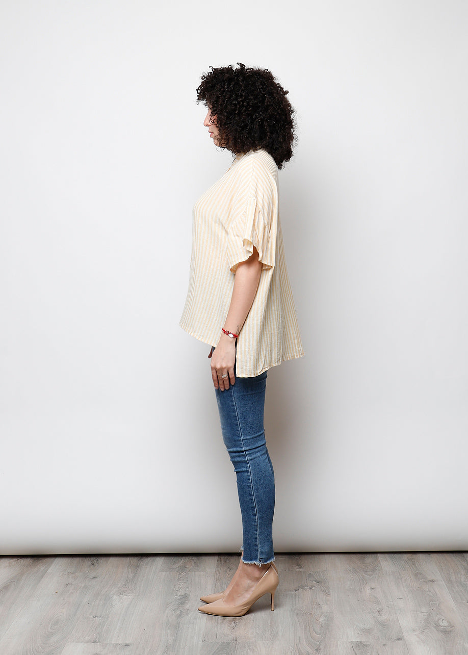 Blusa aperta con bottini rigata