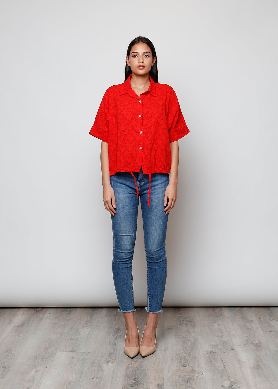 Blusa aperta con bottini