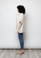 Blusa aperta con bottini rigata