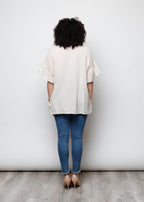 Blusa aperta con bottini rigata