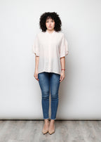 Blusa aperta con bottini rigata