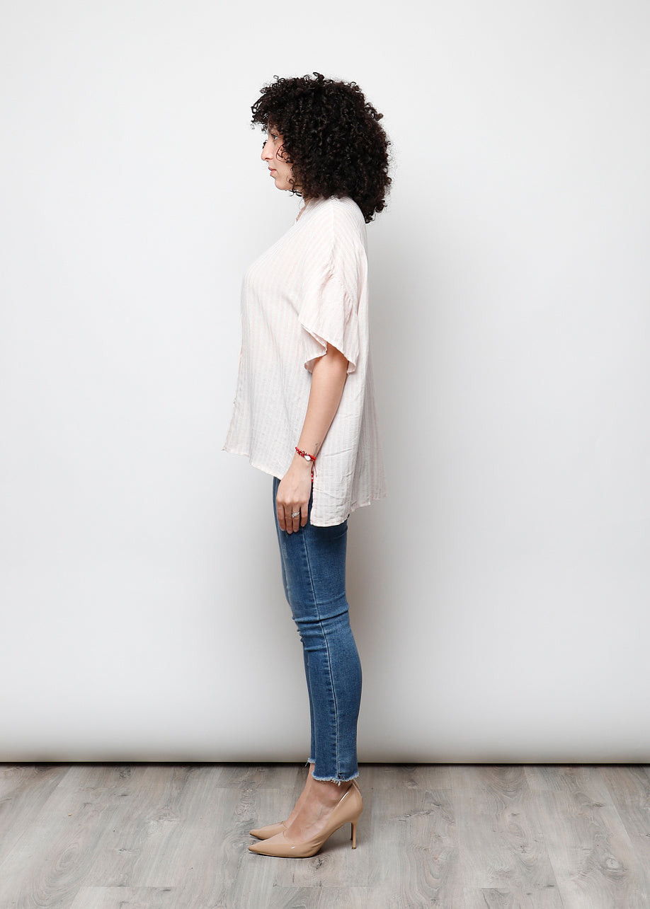 Blusa aperta con bottini rigata