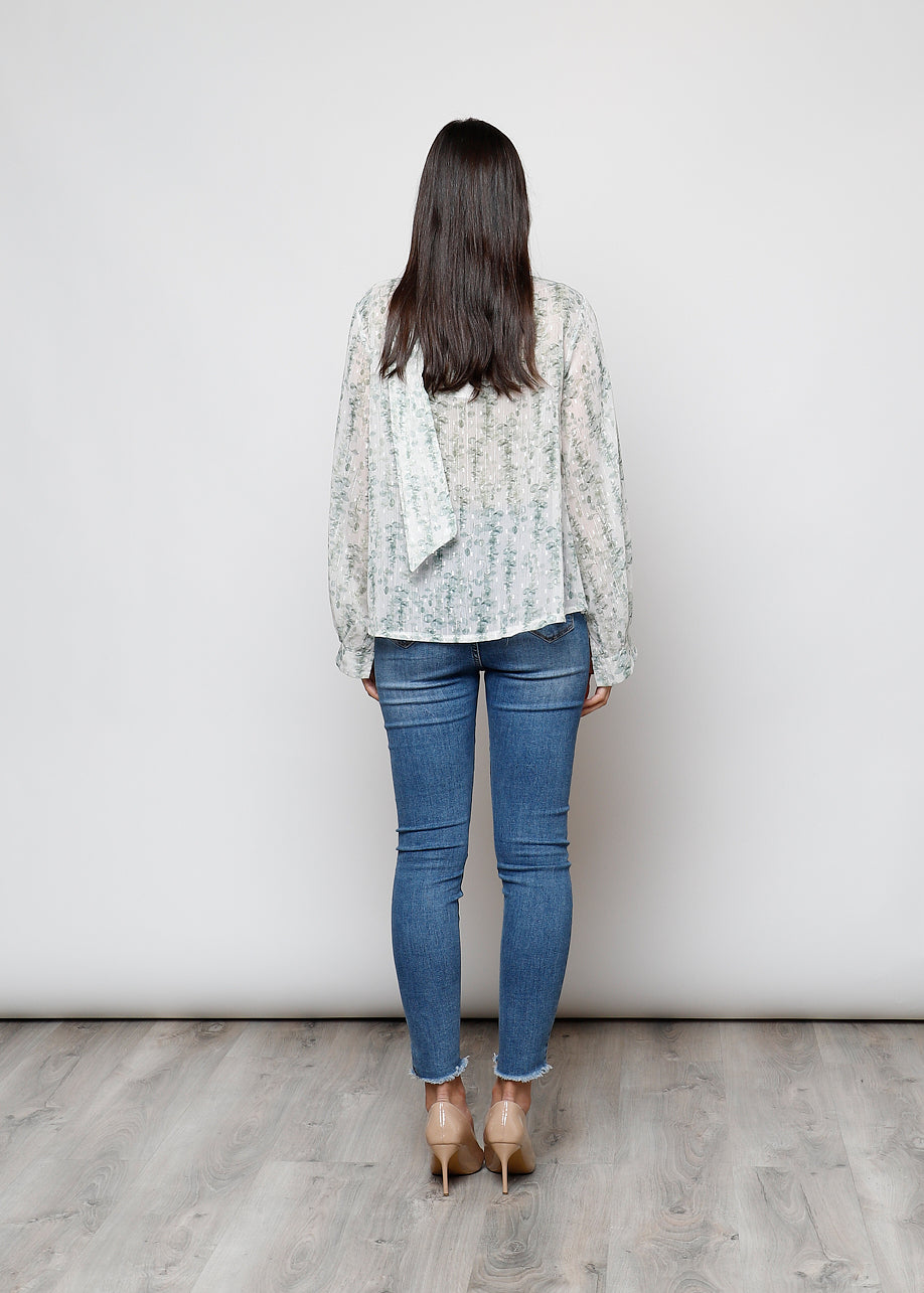 Camicia con fiocco, a manica lunga, stampa floreale con filo lurex.