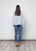 Camicia con fiocco, a manica lunga, stampa floreale con filo lurex.